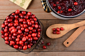 Overhead of a bucket of cranberries and a pot full of whole cran
